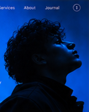 Cobalt-lit portrait from a Kora Kaagaz website hero study